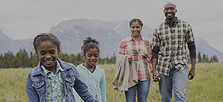 man and woman with their two little girls