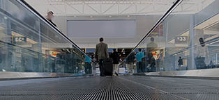 people on moving walkway in airport