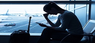 woman in airport looking at tablet