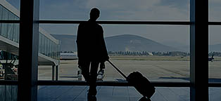 Person waiting on plane looking at airport gate window
